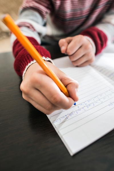 Child Write in a Notebook